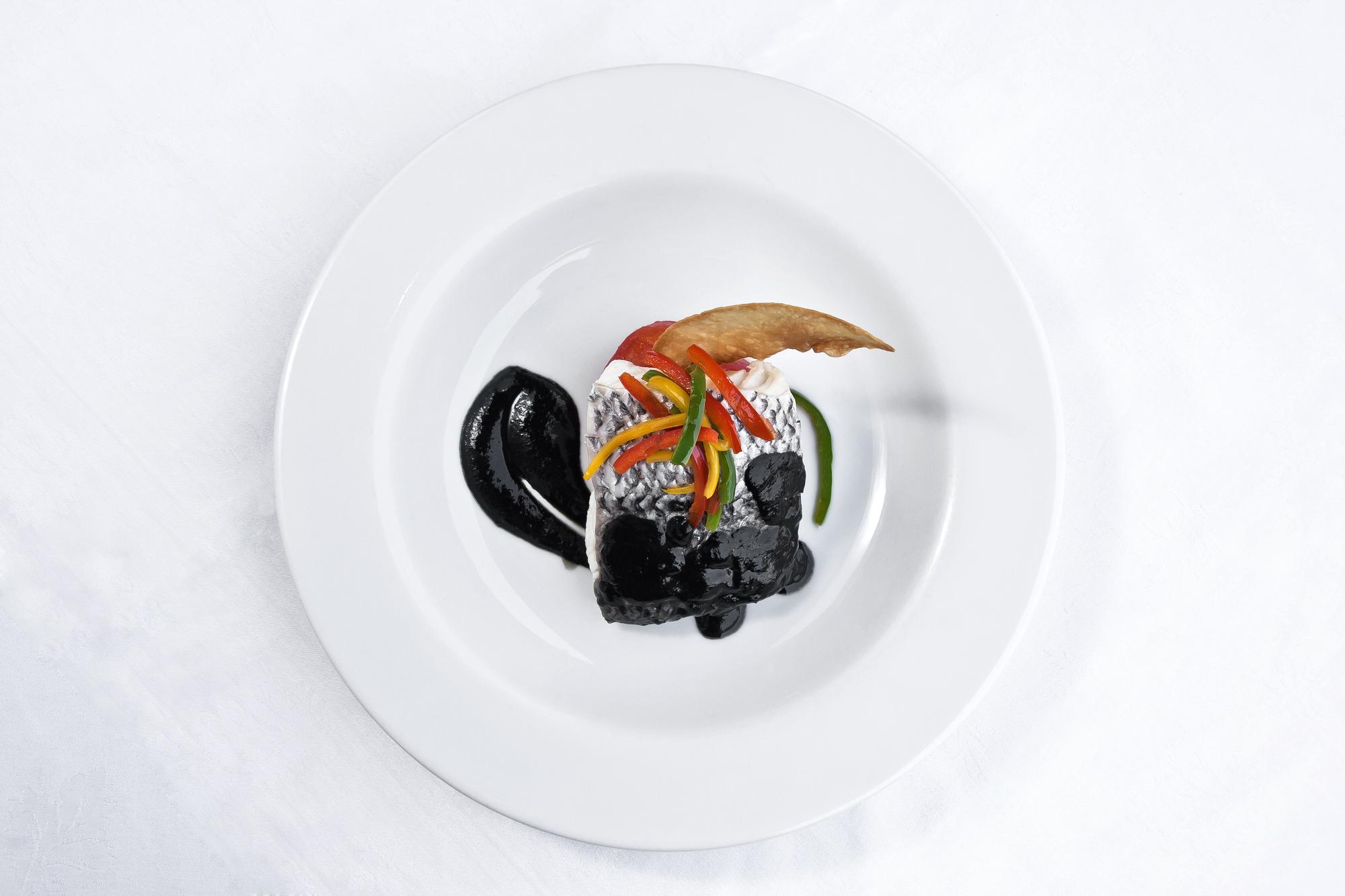 plated seasonal starter on black plate